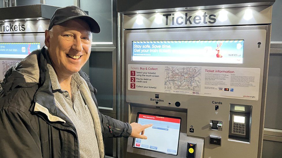 Man using ticket machine at Soham railway station
