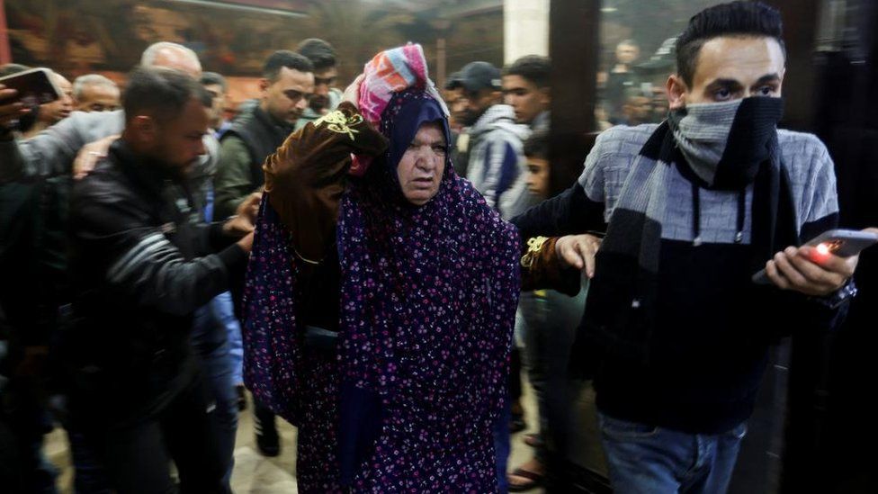 A Palestinian woman is rushed into hospital following an Israeli strike