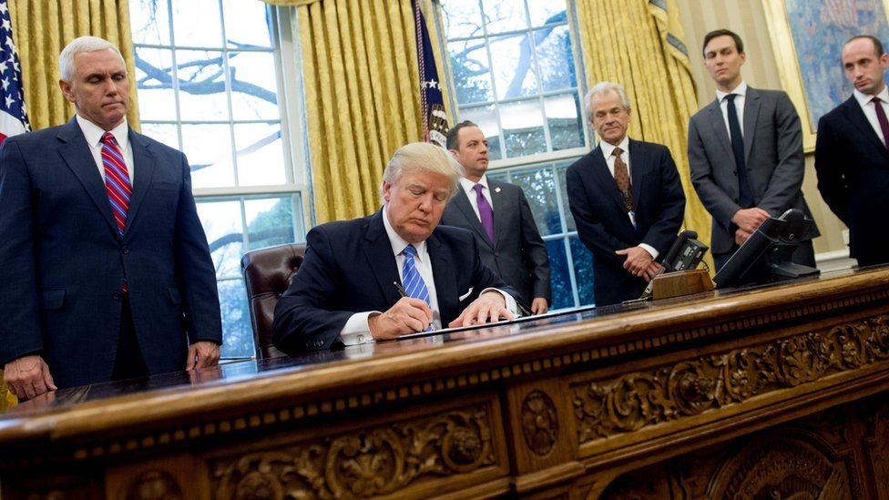 US President Donald Trump signing executive orders in the Oval Office