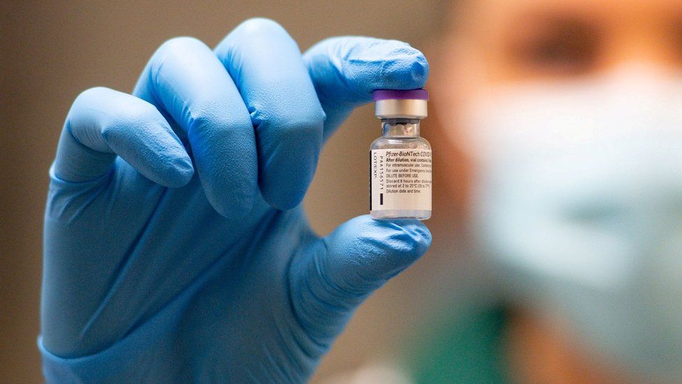 Close-up of a vial of the Pfizer-BioNTech vaccine, held by a nurse at the start of the immunisation rollout in the UK