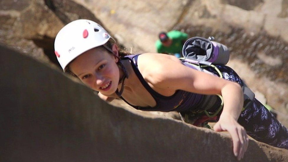 Leah rock climbing