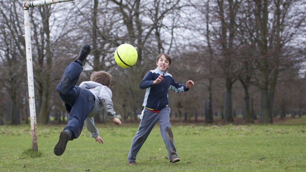 Two boys playing football
