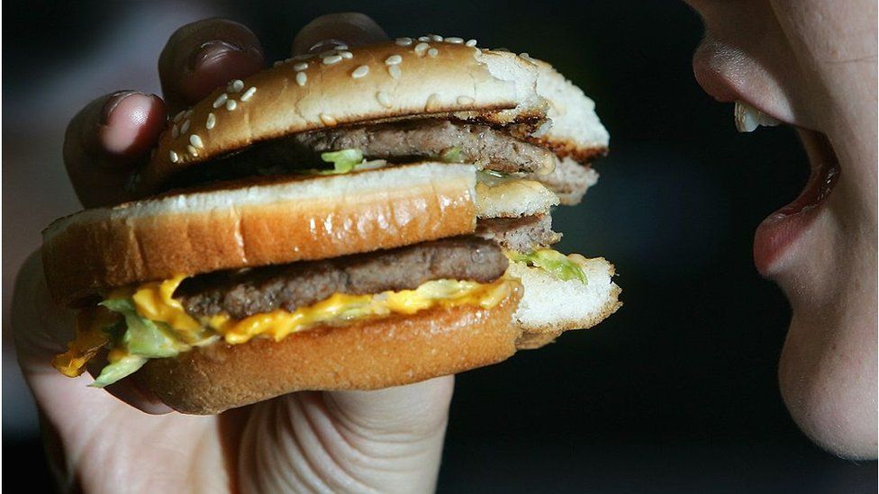 Woman eats McDonald's burger