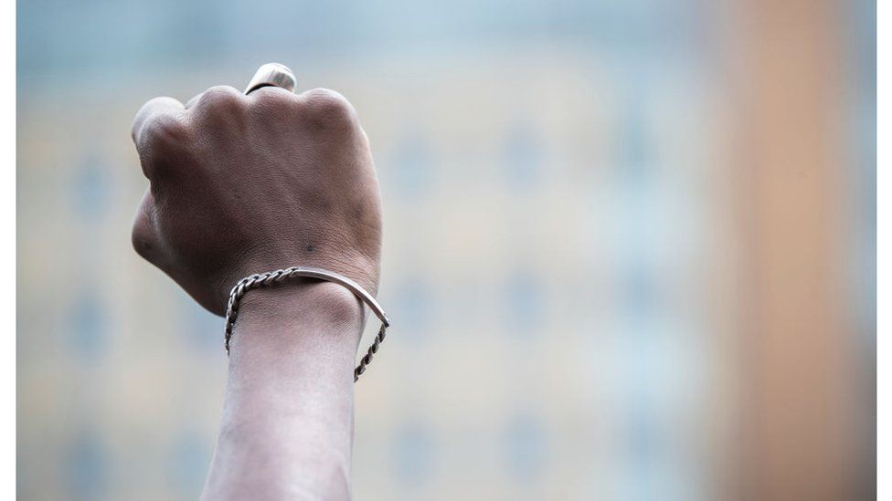 A black protester holds up a closed fist in New York