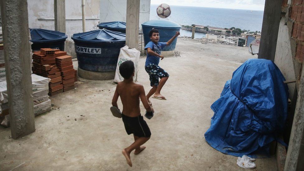 Children play football in the Pavao-Pavaozinho favela