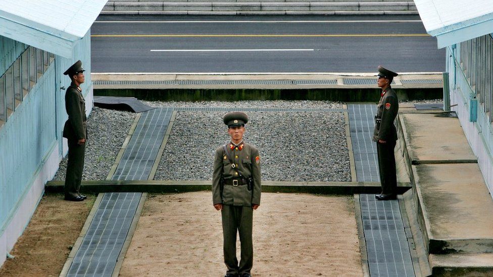 A North Korean soldier stands next to the demarcation line in Panmunjom, on the border between North Korea and South Korea Tuesday 7 August 2007