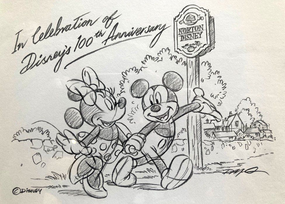 An illustration of Minnie Mouse and Mickey Mouse walking through the village of Norton Disney