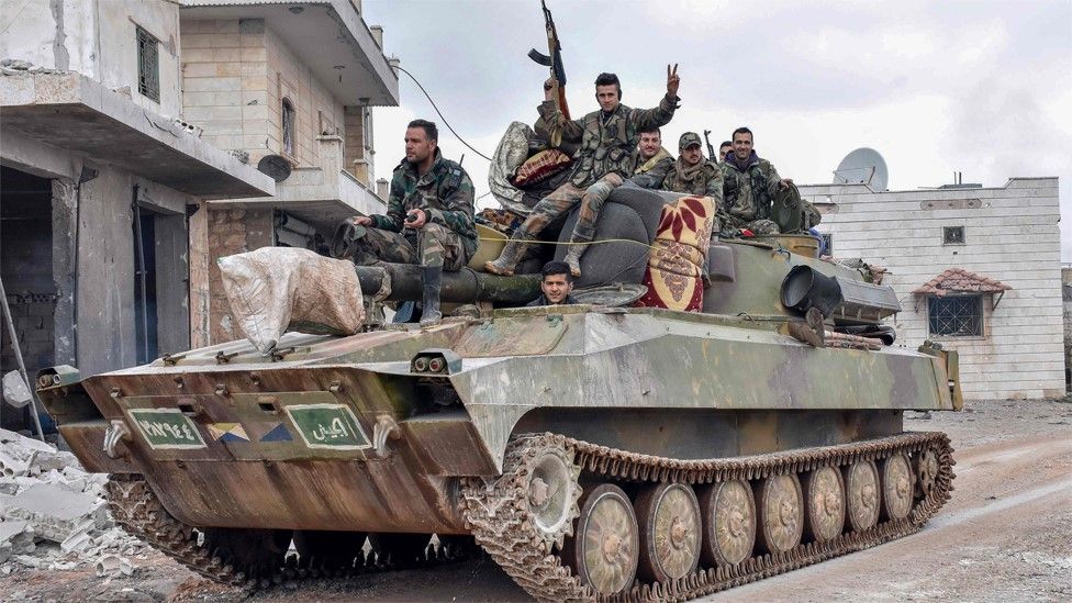 Syrian army soldiers pass through the villages of Deir Sharqi and Talmans, on the outskirts of Maarat al-Numan on 28 January 2020