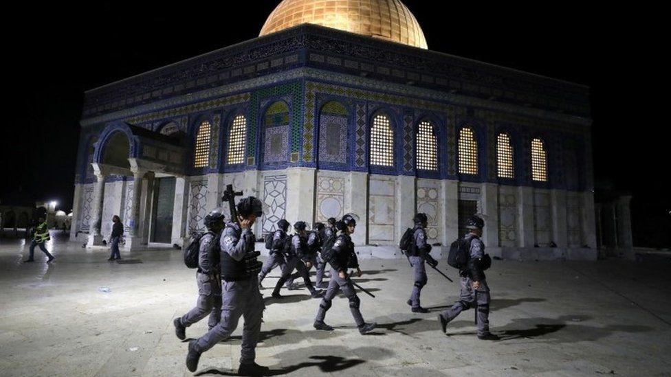 Israeli police walk near the Dome of the Rock during clashes with Palestinians, 7 May