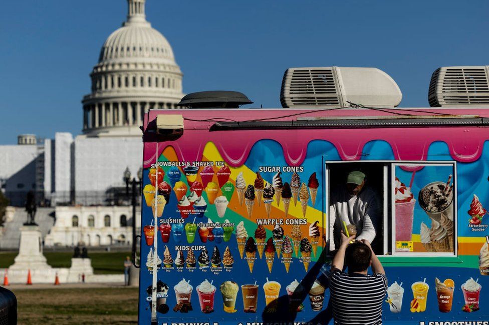 An ice cream truck in front of the US Capitol Building