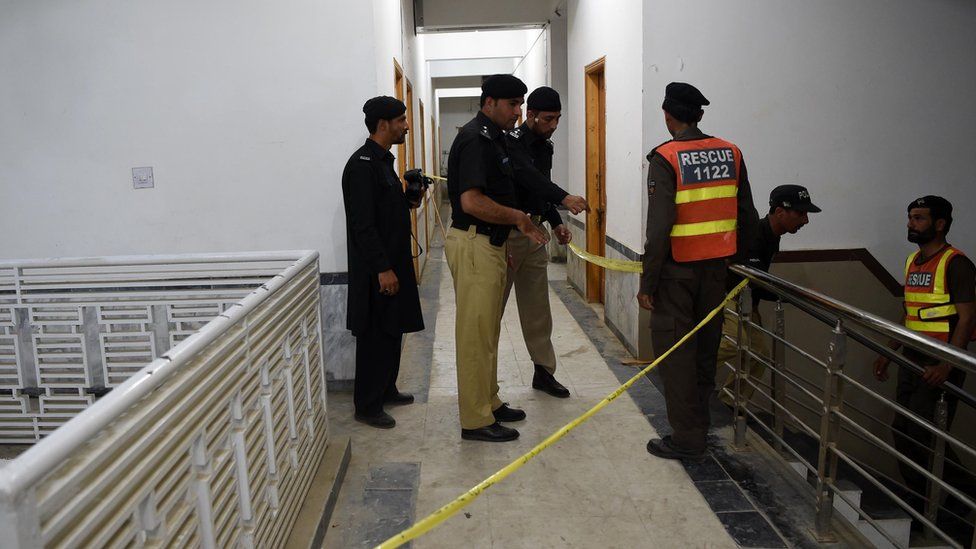 Pakistani police officials inspect a hostel at Abdul Wali Khan university where students beat to death a classmate in Mardan on April 13, 2017.