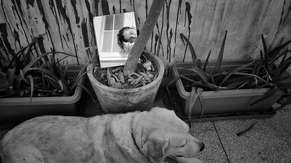 Aparna and her dog, Jules, on her apartment balcony
