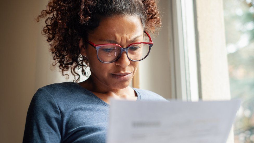 Woman looking at bill