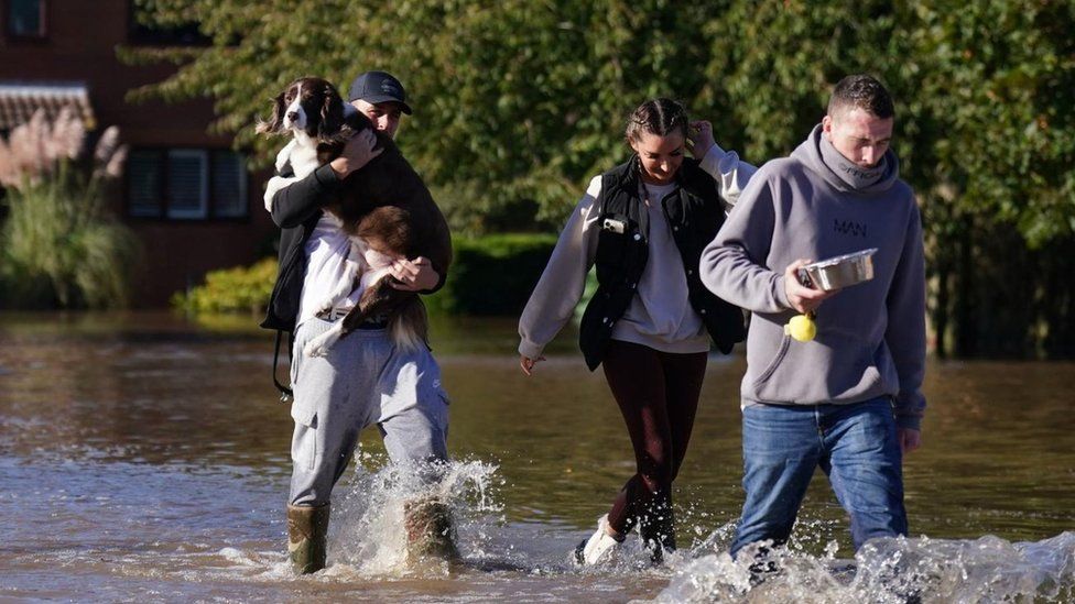 Residents walk through flood water in Retford in Nottinghamshire