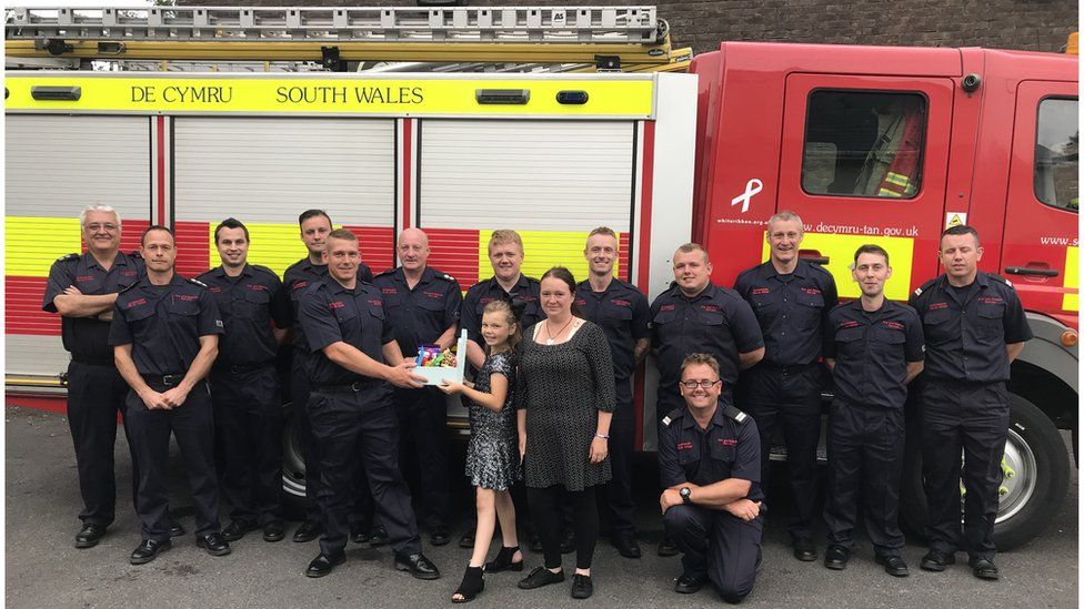 Kelcea and her mum Amie with the Brynmawr fire crew