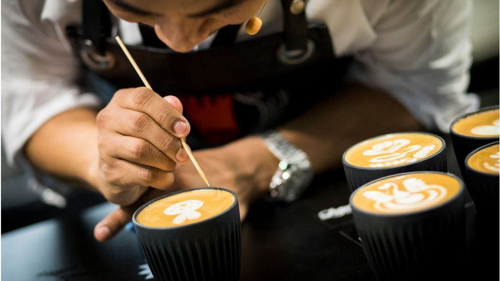 UK Latte Art Champion Dhan Tamang demonstrates latte art during the London Coffee Festival 2019