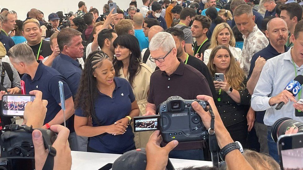 Tim Cook surrounded by journalists