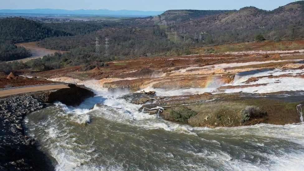 Water from the Oroville Dam Auxiliary Spillway at Lake Oroville continues to flow and has eroded the roadway just below the spillway that leads to the spillway boat ramp on February 12, 2017 in Oroville, California