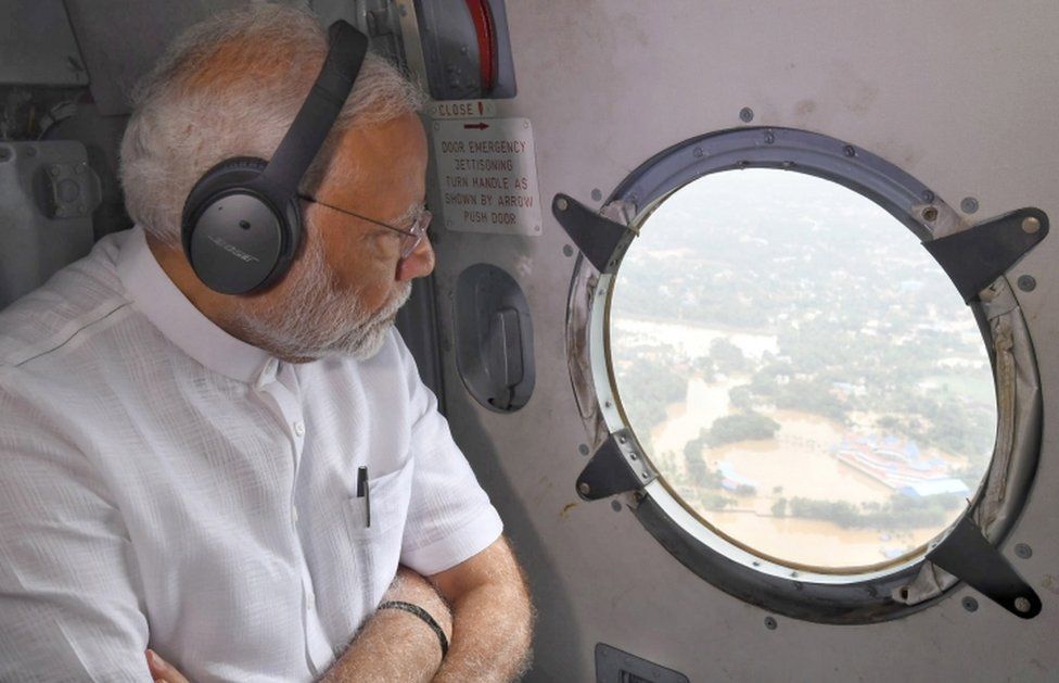 A handout photo made available by the Indian Press Information Bureau (PIB) shows Indian prime minister Narendra Modi conducting an aerial survey of flood affected areas in Kerala