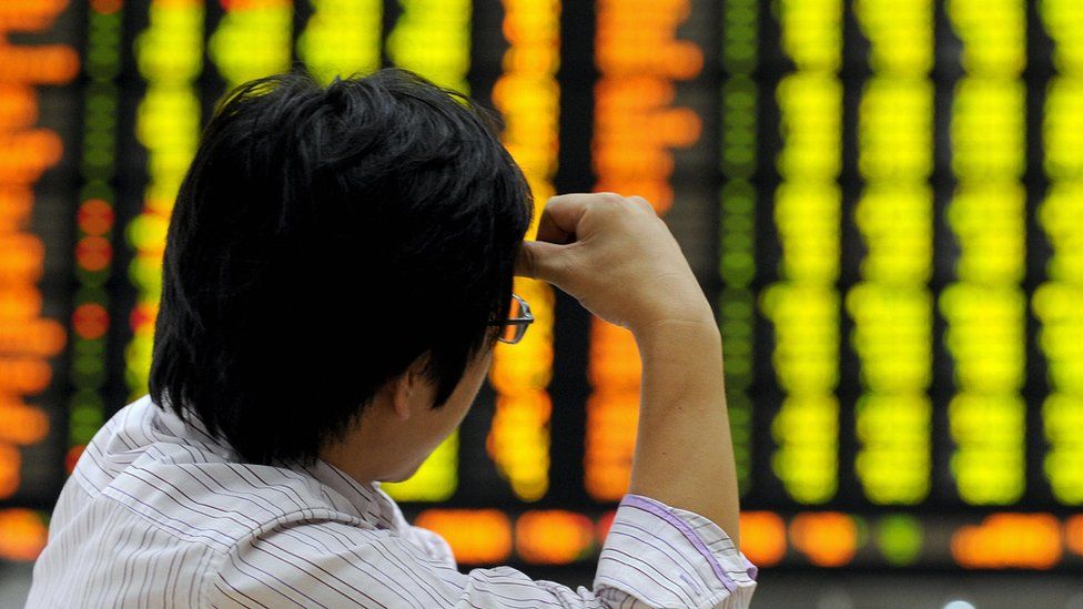 A man looks at stock market board in South Korea