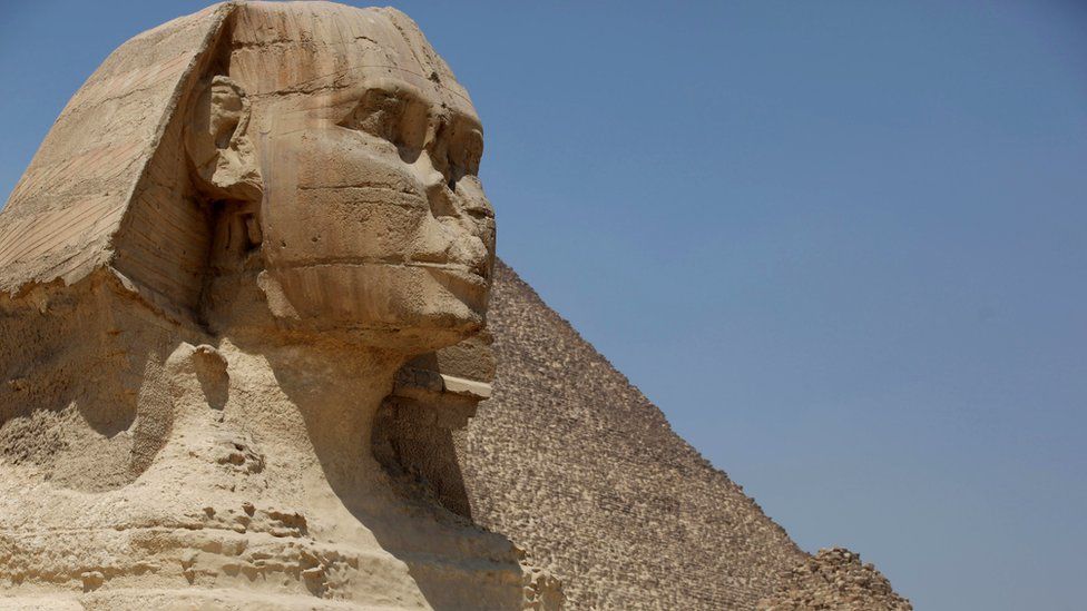 The Great Sphinx of Giza, with a pyramid in the background, Egypt, 27 August 2013.