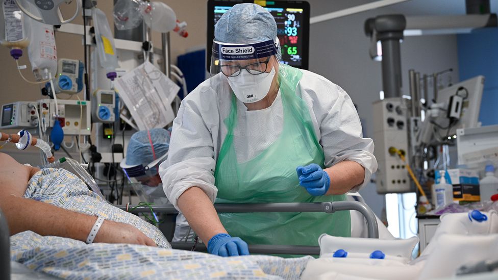 A member of staff at University Hospital Monklands attends to a Covid-positive patient on the ICU ward on 5 February 2021 in Airdrie, Scotland.