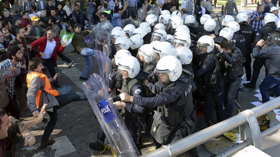 Riot police officer taking on a crowd after explosions in Ankara, Turkey, Saturday 10 October 2015