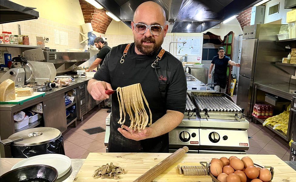 A chef at a restaurant in Italy makes pasta using flour made from crickets