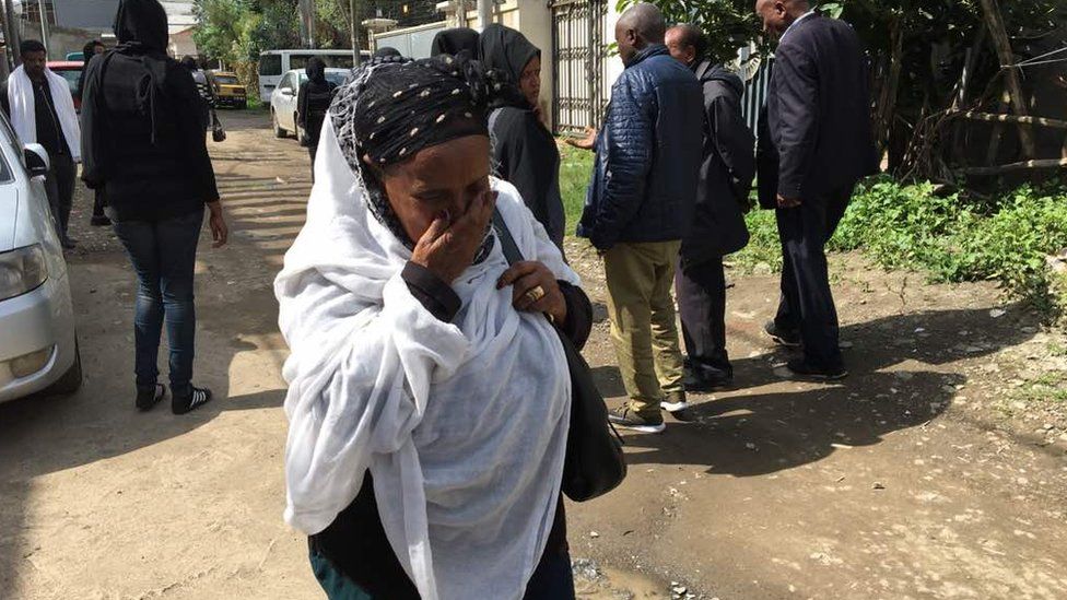 A woman cries as mourners gather near the house of Ethiopian engineer, Simegnew Bekele.