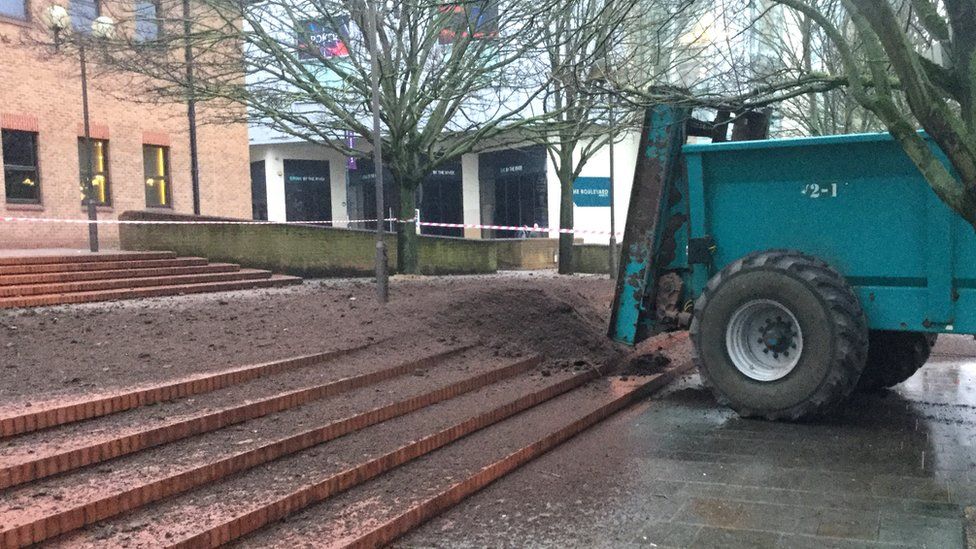 Tractor dumps muck outside Derby Crown Court
