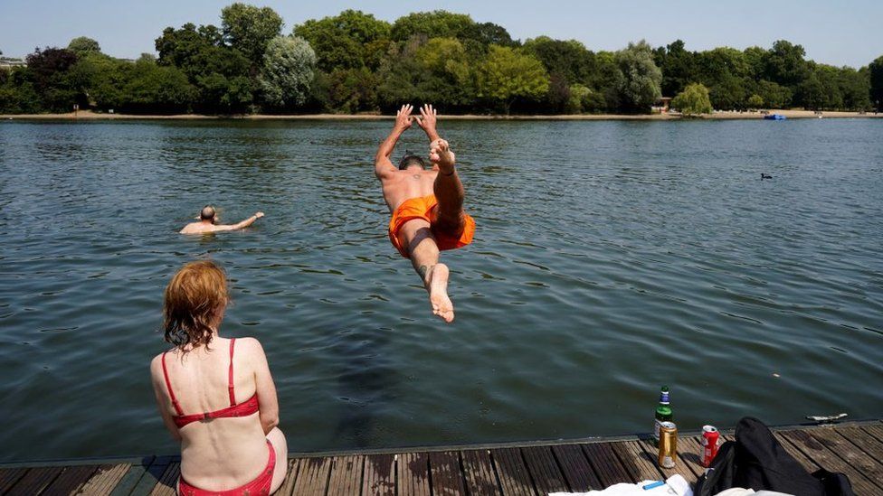 Man jumping into pond