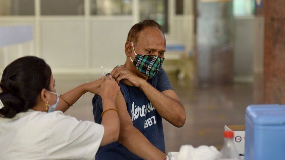 A senior citizen being inoculated with a booster dose of Covid-19 vaccine at District Hospital, Sector 30, on June 12, 2022 in Noida, India.