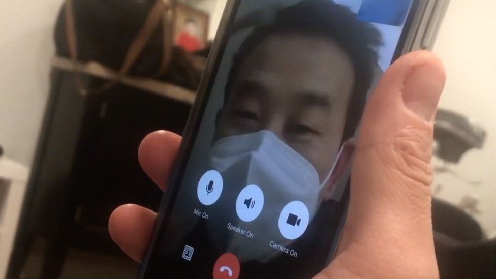 A photo of a phone showing a FaceTime call with a Chinese police officer who had dropped in on Julie Millsap's in-laws
