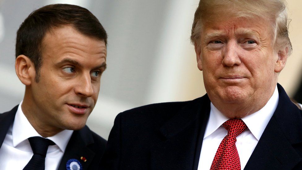 US President Donald Trump (R) is welcomed by French president Emmanuel Macron prior to their meeting at the Elysee Palace in Paris, 10 November 2018