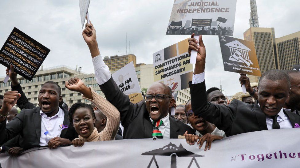 Kenyan advocates hold placards during a picket following a protest call to members by the Law Society of Kenya against recent remarks by Kenya's President, William Ruto, accusing the judiciary of wide spread corruption and lacking in integrity, in the Central Business District in Nairobi on January 12, 2024.