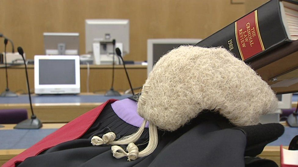 barrister gown and wig in a courtroom