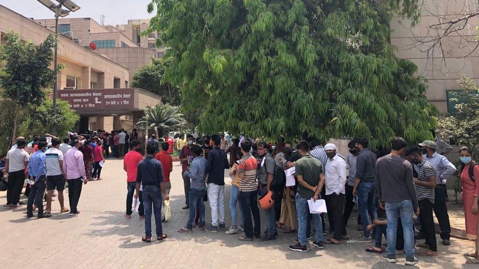 People waiting to be screened and tested outside a government-run hospital in Noida.