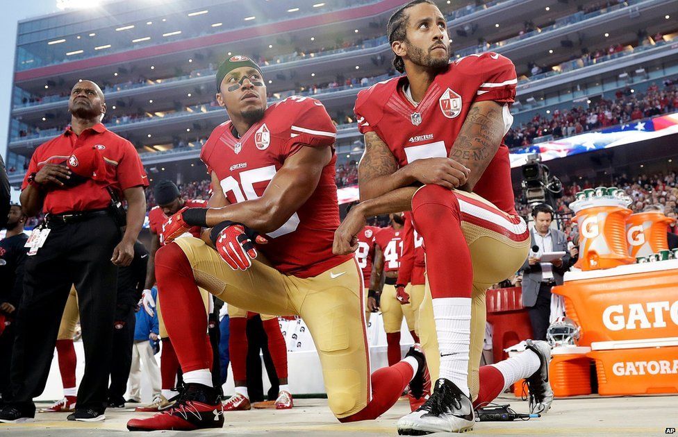 San Francisco 49ers safety Eric Reid and quarterback Colin Kaepernick kneel during the national anthem before an NFL football game on 13 September
