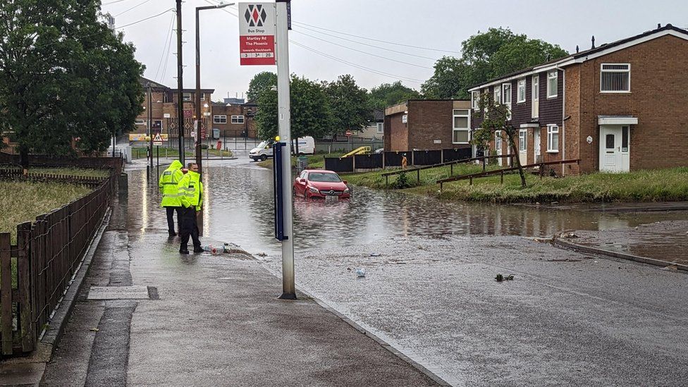 Car in flooded road in Oldbury