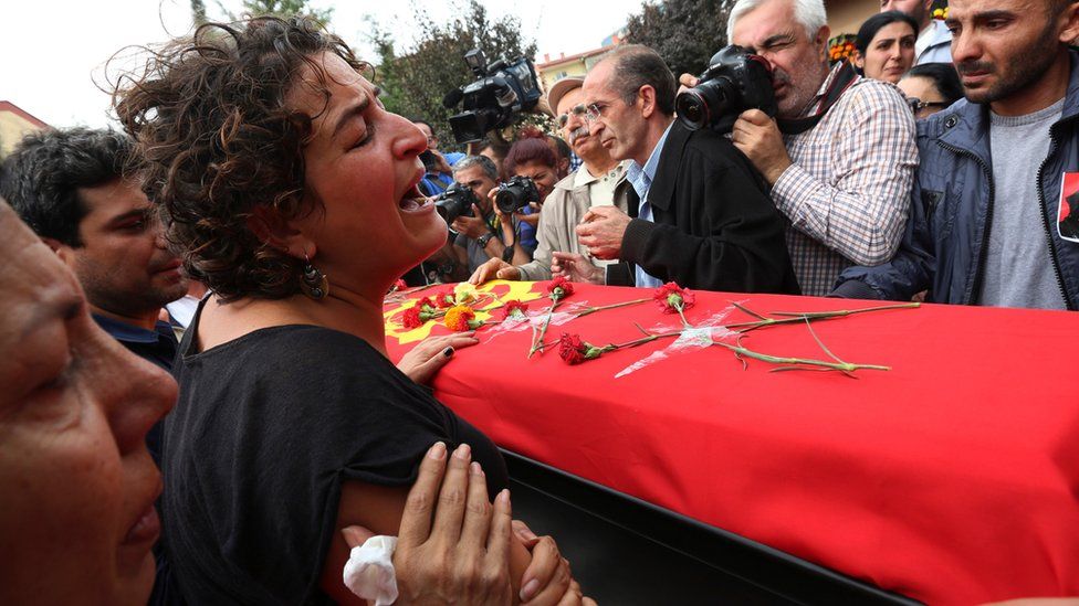 A relative cries over the coffin of Korkmaz Tedik, 25, killed in Saturday's bombing attacks in Ankara