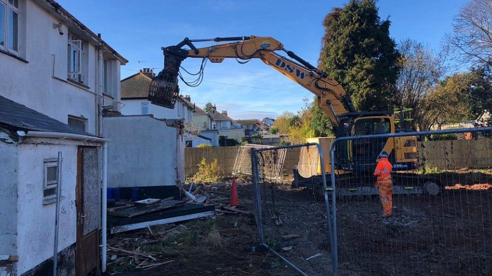 Digger starts demolishing house