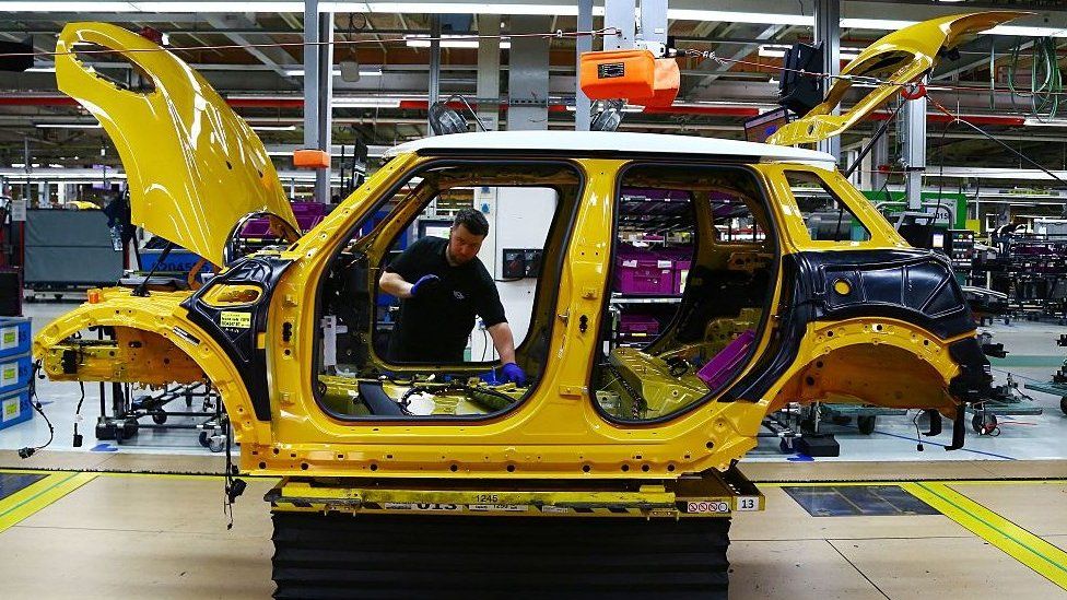 A car being assembled in a factory