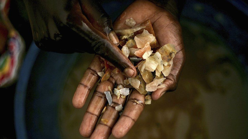 Hand holding minerals in DR Congo