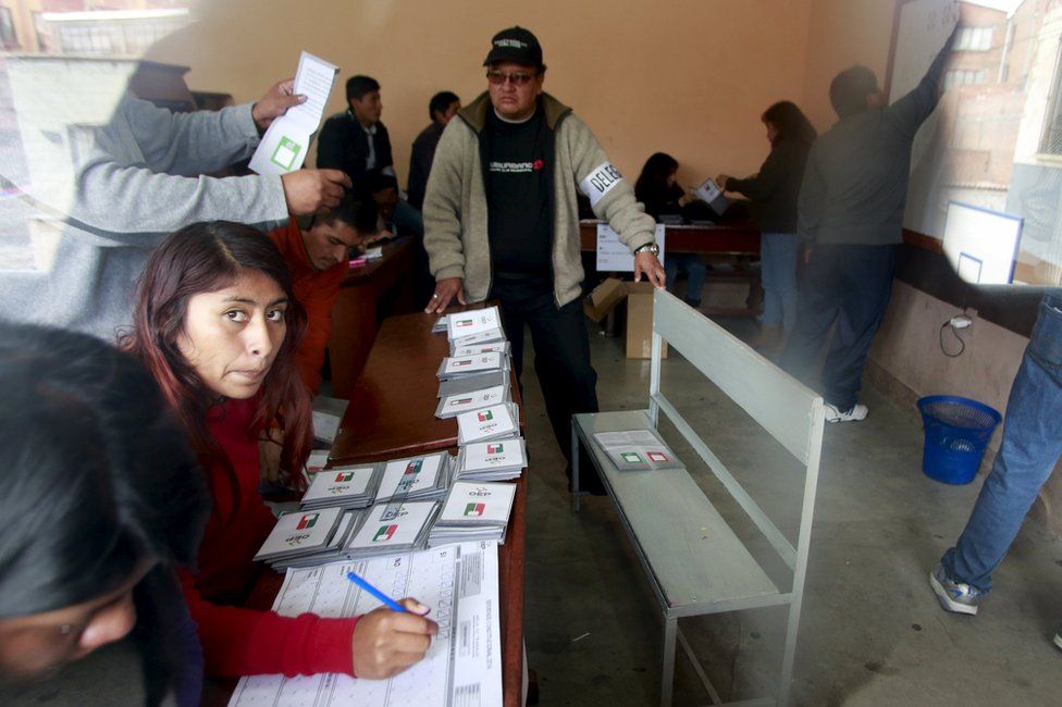 Members of the electoral polling committee count votes during a national referendum in La Paz, Bolivia, 21 February