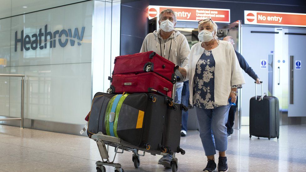 Passengers from the Holland America Line ship Zaandam walk through arrivals in Terminal 2 at Heathrow Airport in London, after flying back on a repatriation flight from Florida.