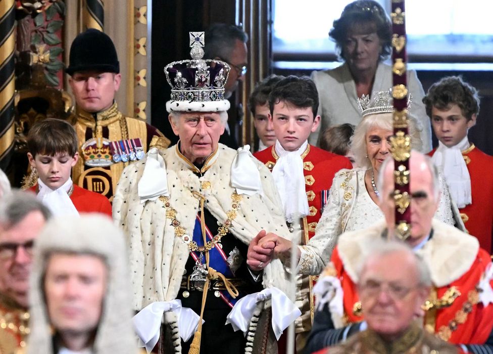 King Charles III, wearing the Imperial State Crown and Robe of State, and Queen Camilla, wearing the George IV State Diadem for the first time, arrive for the State Opening of Parliament in the House of Lords, at the Palace of Westminster, London.