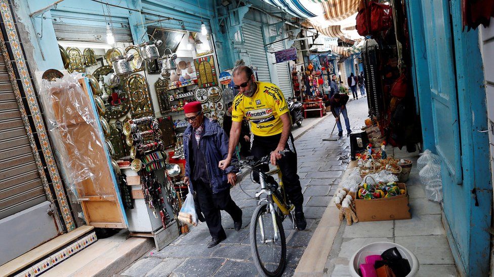 Sunday 12 February, a man rides his bicycle through the Kasbah souk, in the old town of Tunis, Tunisia.