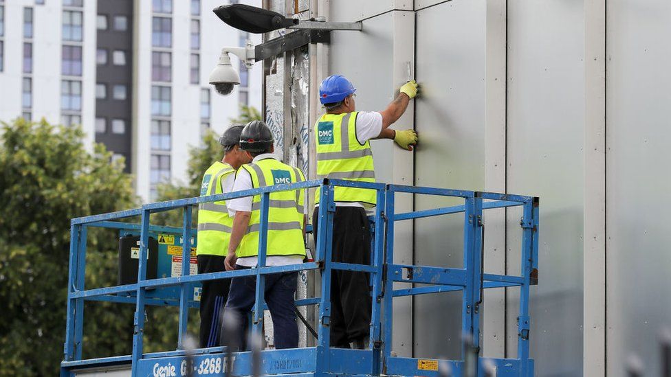 File pic of cladding being removed from a building in Salford
