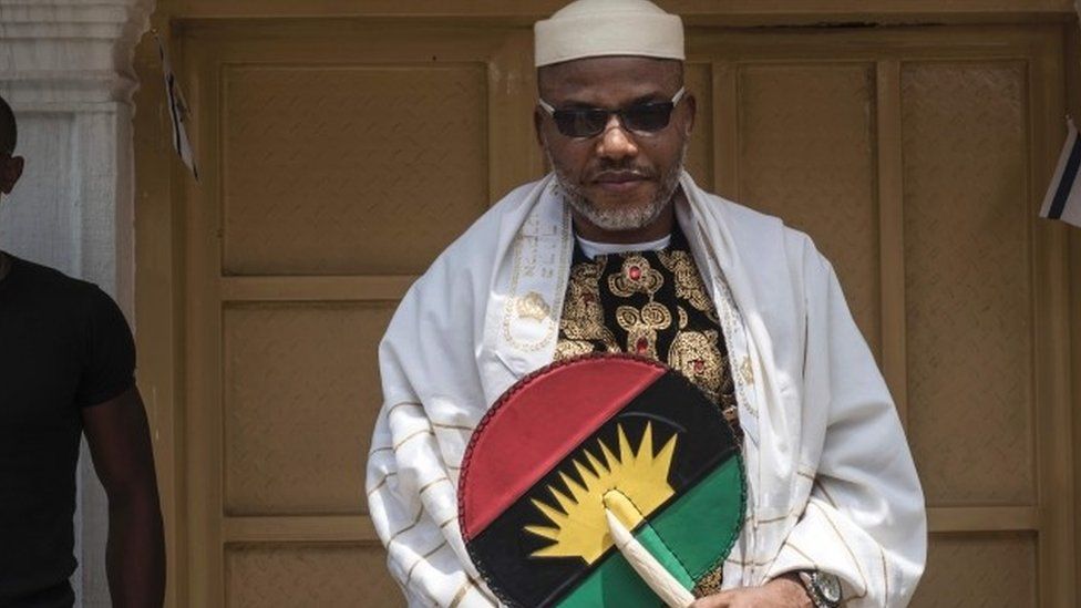 Political activist and leader of the Indigenous People of Biafra (IPOB) movement, Nnamdi Kanu (L), wearing a Jewish prayer shawl, poses in the garden of his house in Umuahia, southeast Nigeria, on May 26, 2017