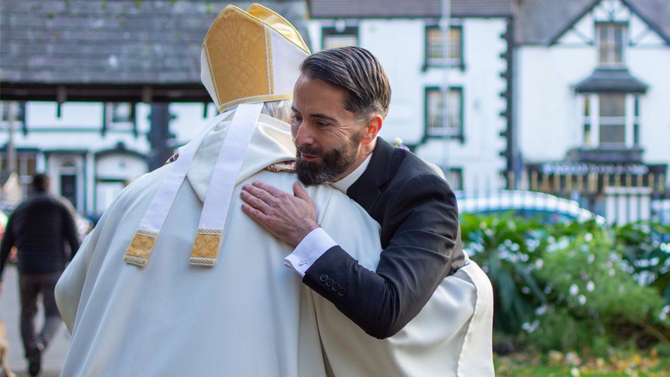 Right Reverend Gregory Cameron and Father Lee Taylor embrace